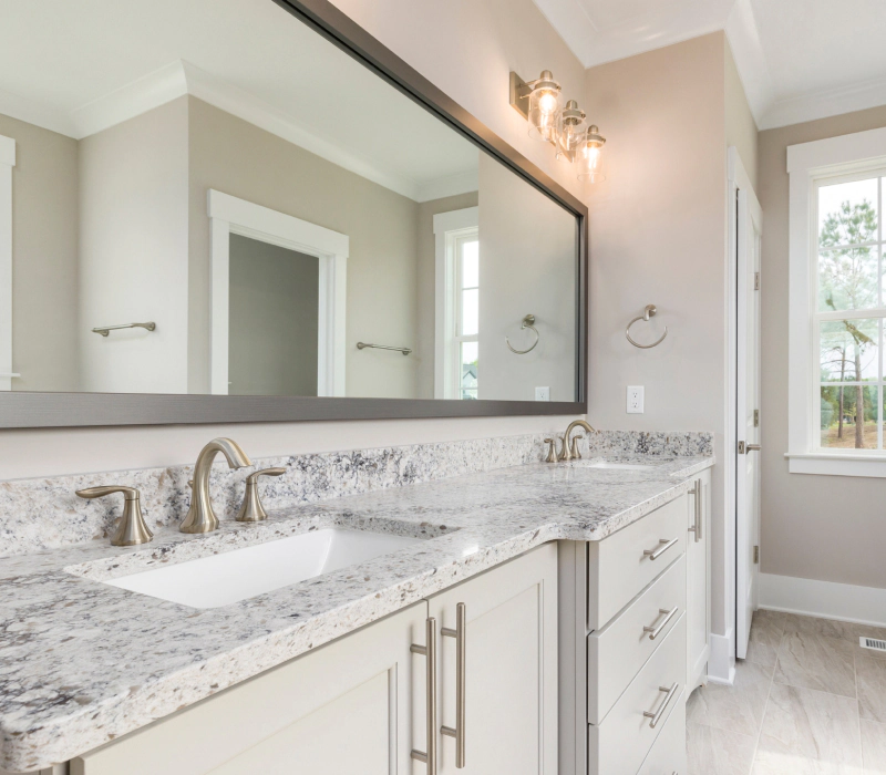 newly renovated modern master bathroom with wide mirror